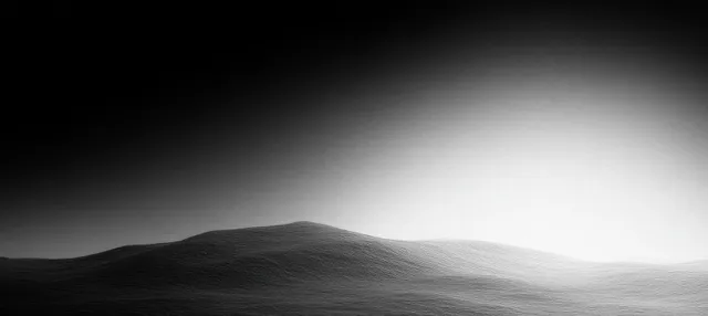 Grayscale abstract hills beneath a soft light gradient with subtle film grain texture.