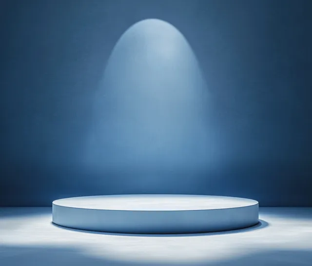 Minimalist circular podium on a soft blue background with diffuse light and subtle shadow.