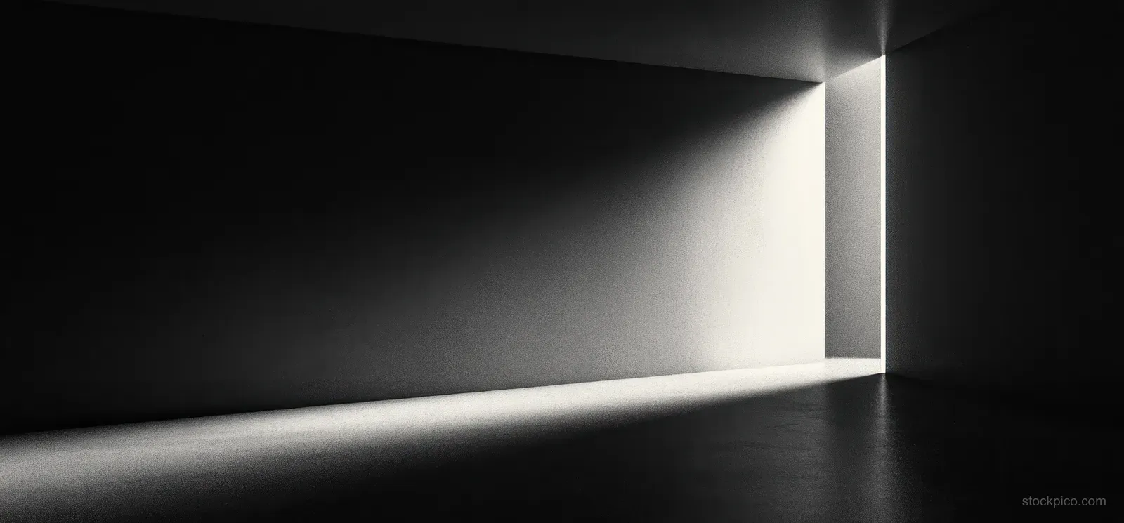 Monochromatic spotlight beam illuminates a dark corridor floor and walls with smooth gradient and subtle grain.