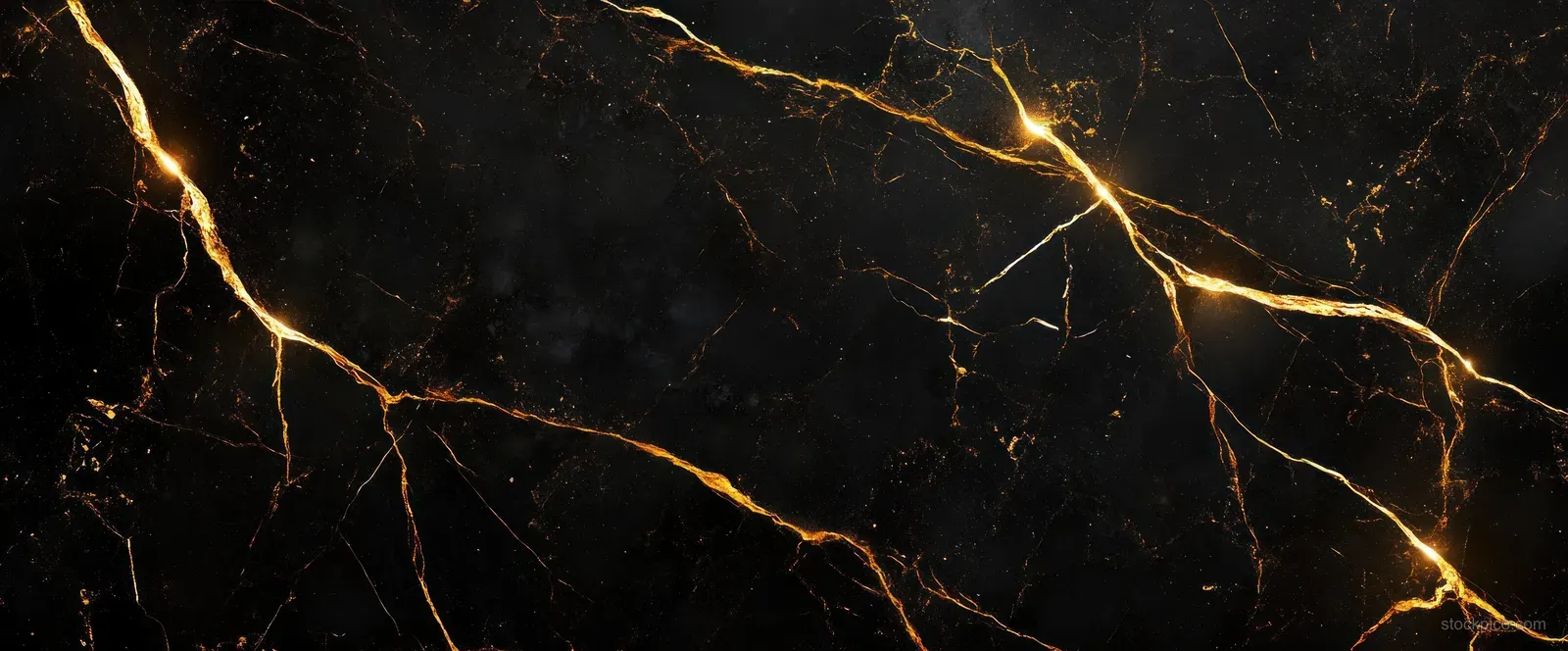 Close-up of black marble with glowing golden veins under moody ambient lighting.