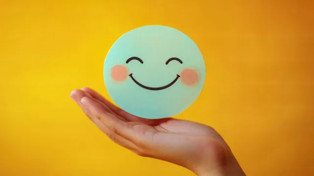 Hand holding smiling thinking face icon for mental health assessment concept