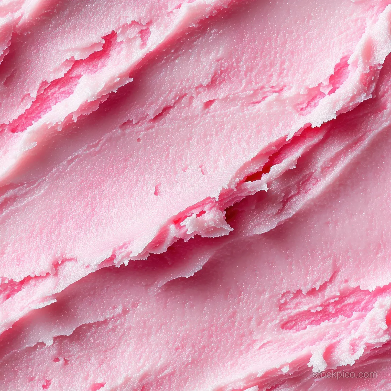 Macro close-up of pink creamy sugar scrub gel texture with visible granules and swirling ridges.