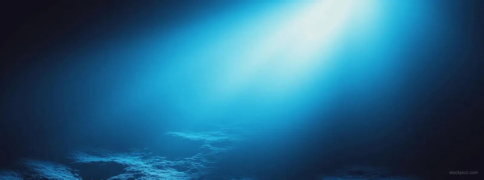 Blue gradient abstract background with a bright spotlight glow, soft light rays, and grainy texture.