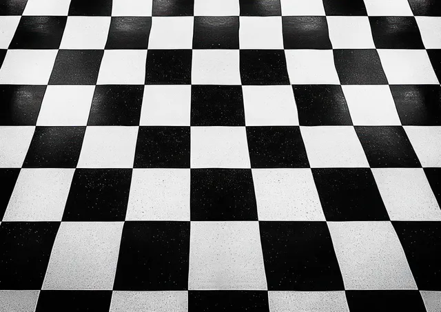 Black and white checkered floor tiles arranged in a geometric grid pattern indoors.