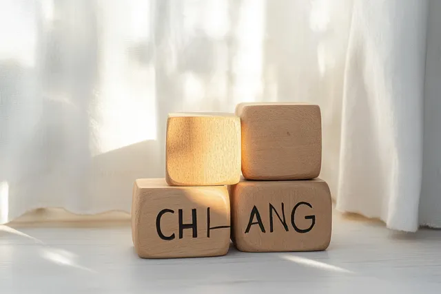 Wooden block cubes spelling CHANCE and CHANGE on a bright windowsill background