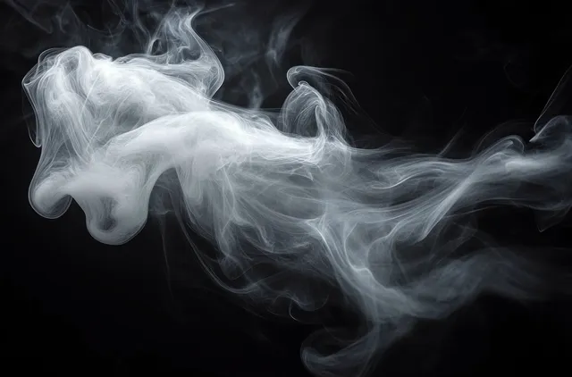 White smoke curls and swirls across a black background.