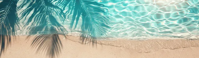 Turquoise ocean surf and palm-leaf shadow on sandy beach top-view banner with copy space