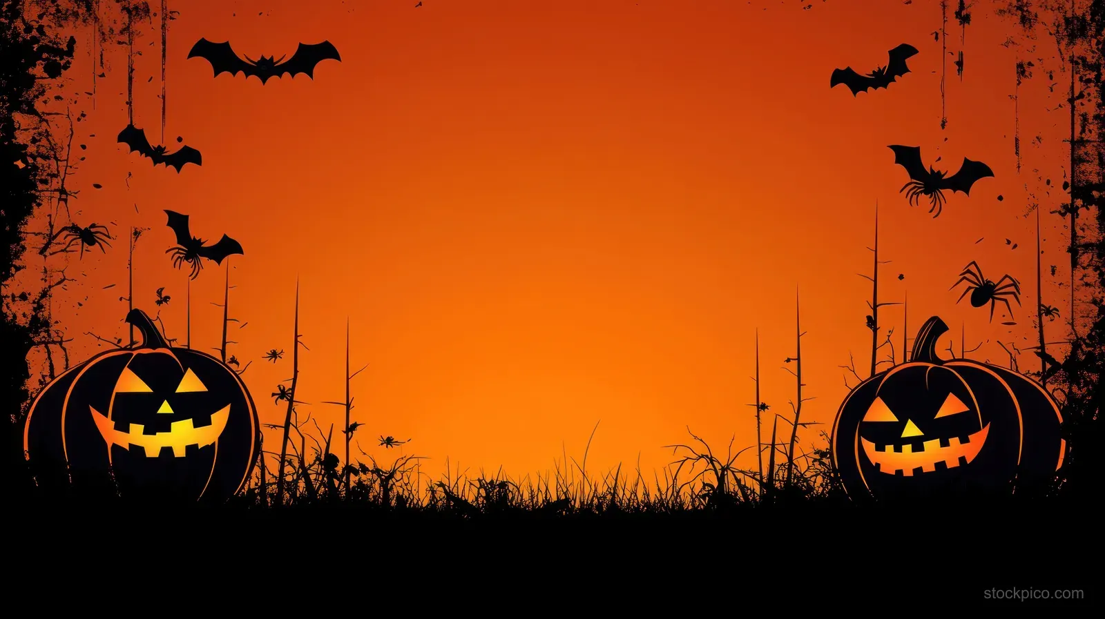 Two glowing jack-o-lanterns on dark grass with bats and spiders flying around an orange Halloween sky.