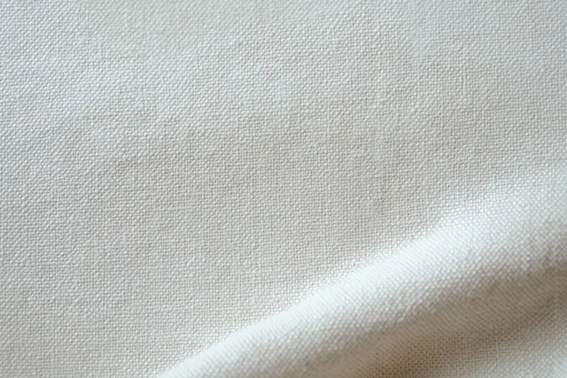 Cream paper canvas texture with subtle ripples and soft folds in neutral light