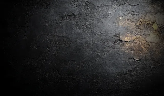 Weathered dark concrete wall surface with cracks, peeling patches, and soft ambient side lighting.