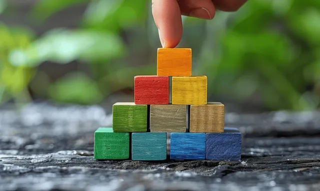 Stacked wooden blocks on a stone path showing stepwise business planning milestones