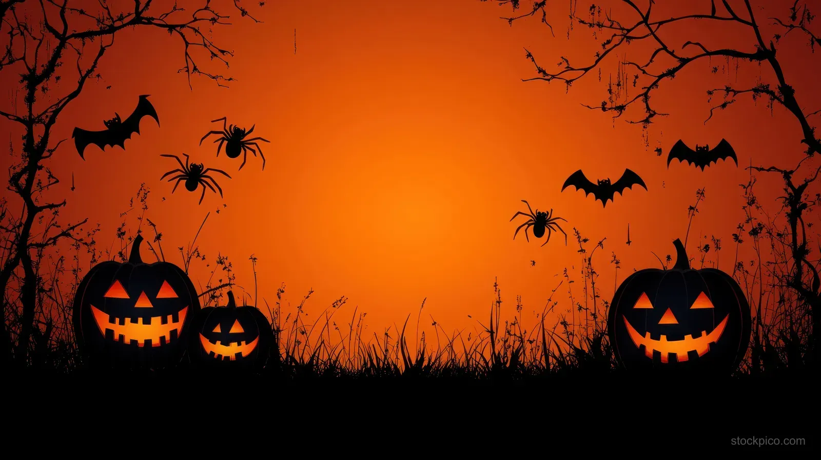 Three glowing jack-o-lanterns sit in grass beneath bare branches and bats against an orange sky.