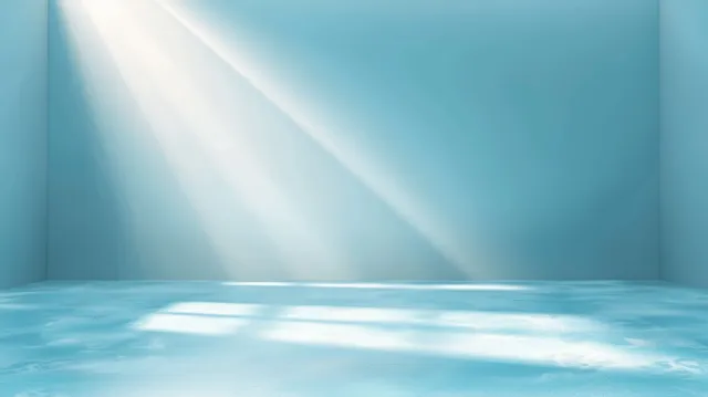Light blue studio corner with white sun-ray beams striking an empty product display platform.