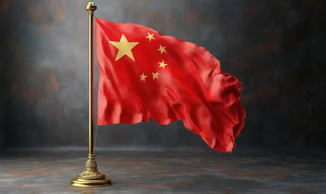 A red flag with yellow stars waves on a brass stand against a dark textured background.