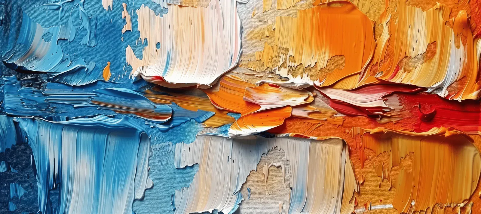 Closeup abstract oil paint on canvas with raised palette knife strokes in blue and orange tones and layered textures.