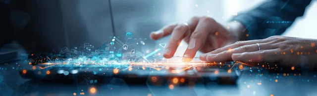 A man’s hand uses a tablet with futuristic sales analytics graphics while working in an office.