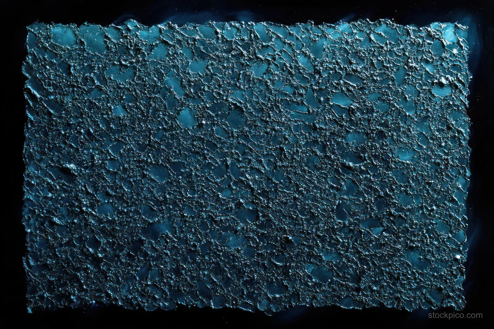 A cracked, pitted metal plate surface illuminated by blue light against a dark background.