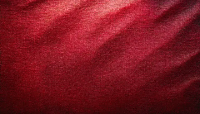 Red canvas fabric texture with dramatic diagonal light and deep shadow folds