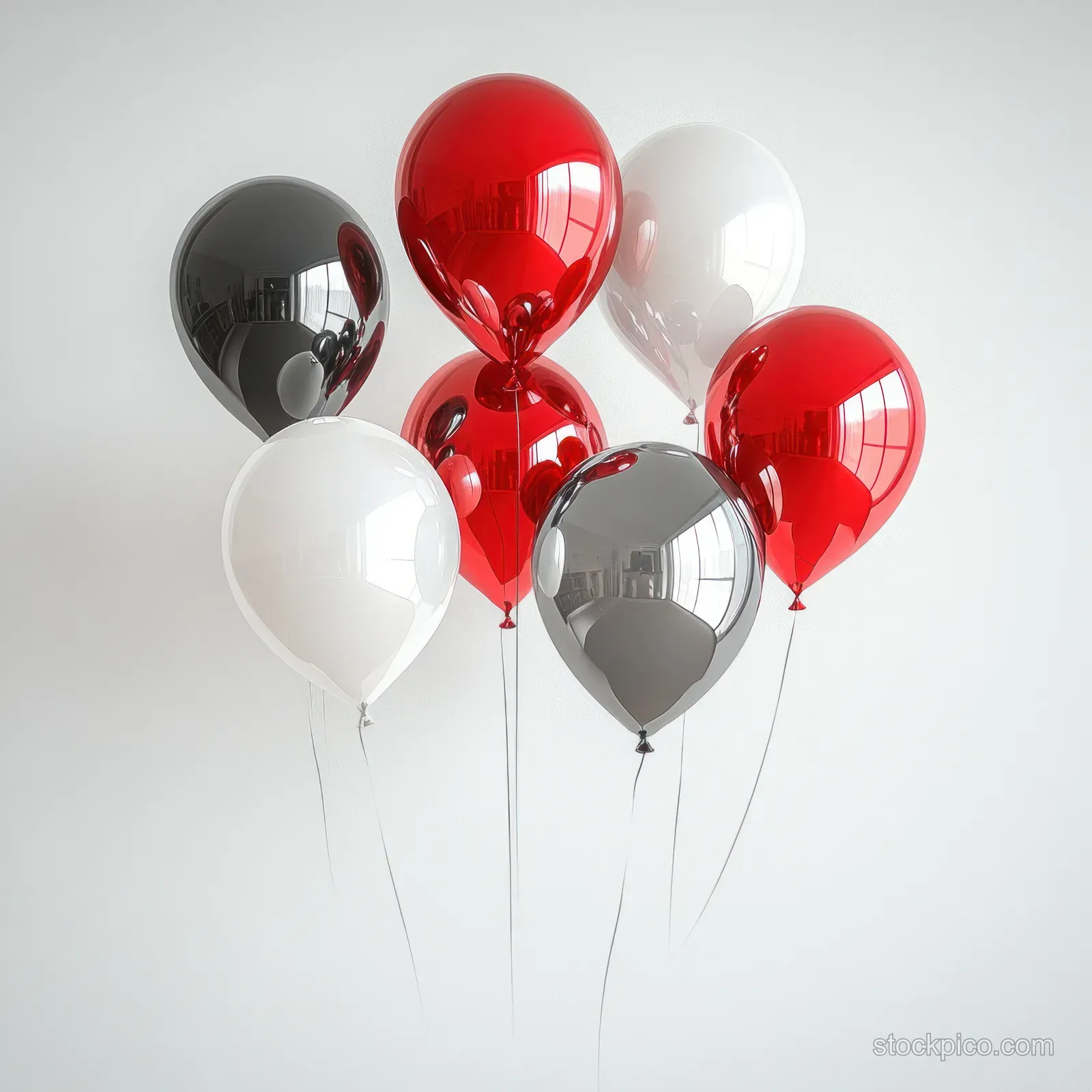Red, black, white, and silver metallic balloons float on a plain white background with thin strings visible.