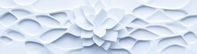Silver and white geometric relief wall with layered diamond shapes and soft shadows.