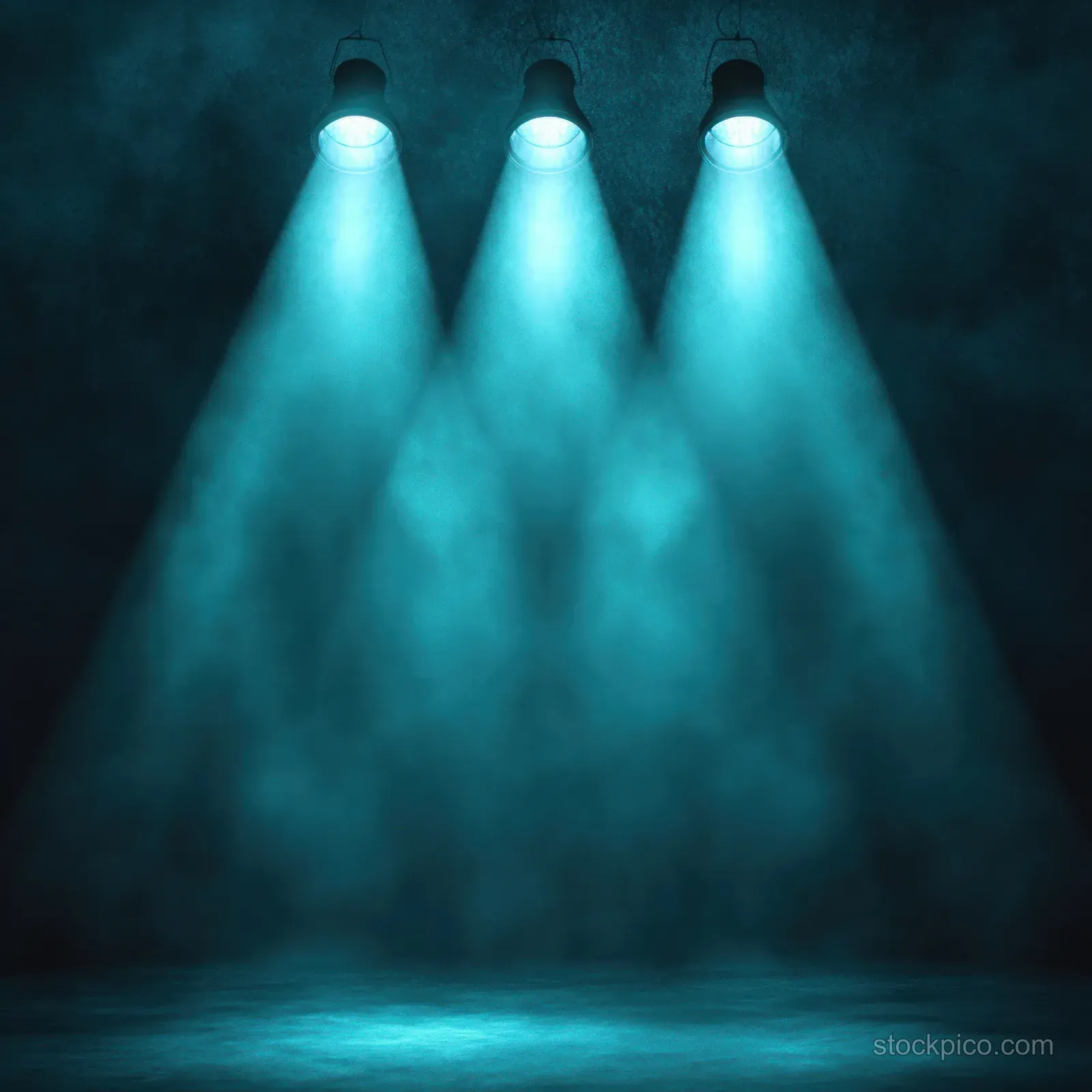 Three turquoise spotlights cast misty beams onto a dark stage floor.