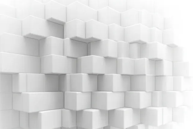 Staggered white cubes interlock on a textured wall, forming a geometric 3D pattern with visible depth.