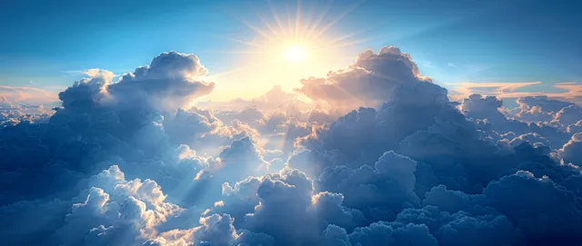 Sun rays break through blue sky clouds, creating a bright summer atmosphere