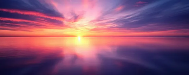 Vibrant sunset reflecting across calm waters beneath a purple orange sky
