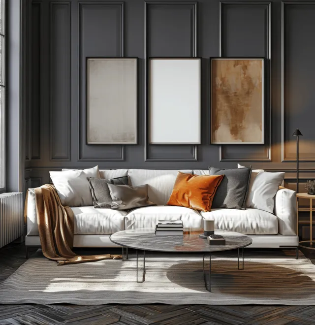 Three empty frame mockups hang above a white sofa in a dark gray living room with wooden floor and soft light.