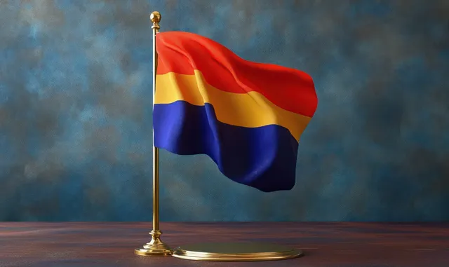 A small tri-color flag with horizontal red, yellow, and blue stripes waves on a gold tabletop pole against a textured blue and brown background.