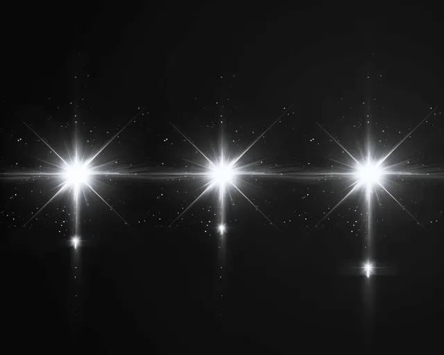 White glowing lens flares streak across black night background with sparkling light rays