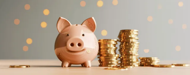 3D piggy bank beside floating golden coins on a desk with warm light bokeh