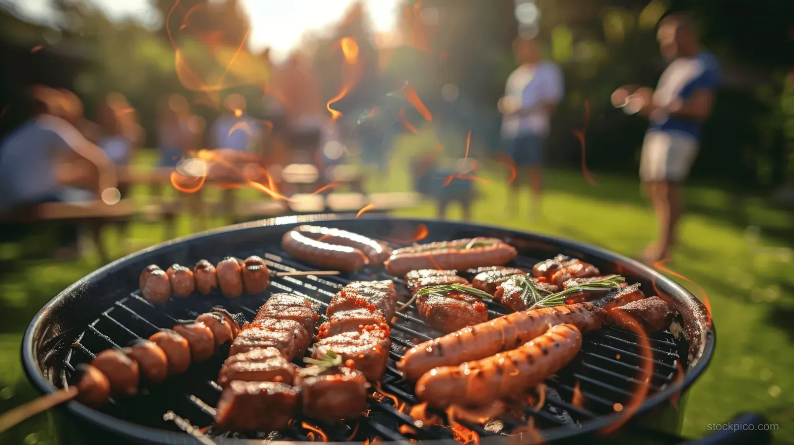 A cheerful family and friends gather for a sunny summer barbecue picnic in a vibrant garden, enjoying grilled sausages and meat.