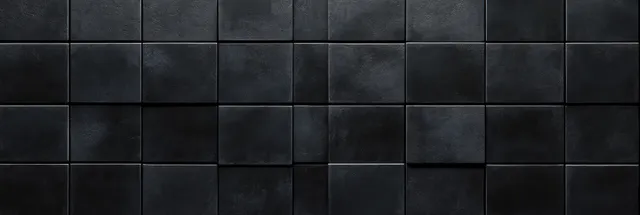 Close-up of a black tiled interior wall with square tiles arranged in a grid and visible grout lines.