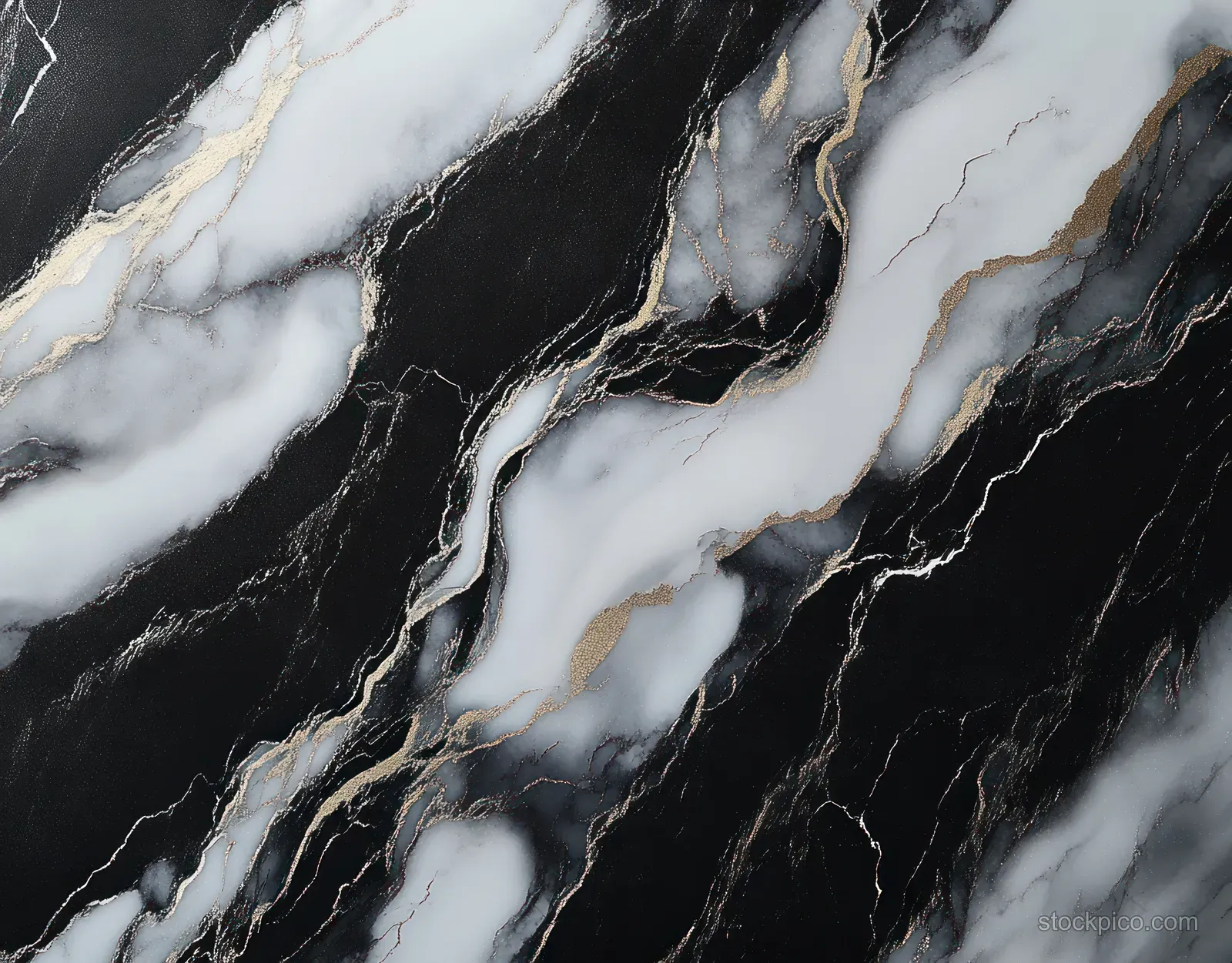 Close-up of black and white marble with gold veining and swirling streak patterns on a polished surface.