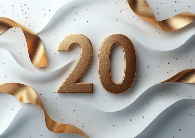 Gold “20” anniversary number rests over flowing white ribbon with scattered confetti on a light background.