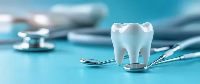 Tooth model and dental tools on blue clinic table for hygiene and prevention