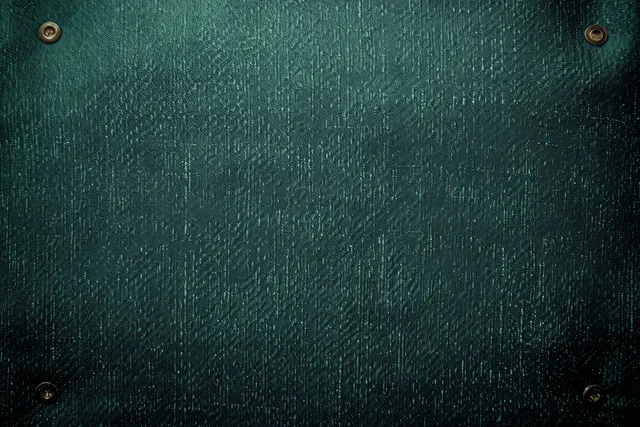 Dark green fabric texture background with centered white geometric pattern and rivet details