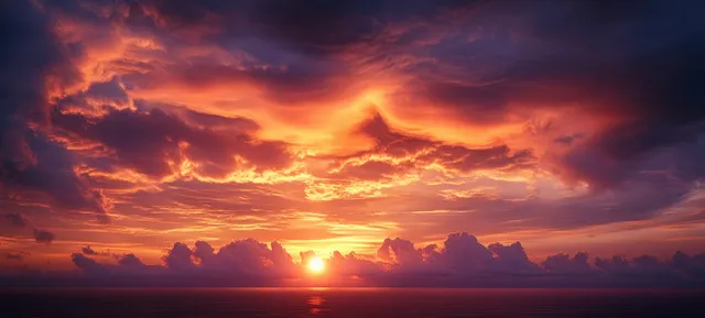 Sunset over calm ocean with glowing clouds, warm sun path, and vivid sky reflections