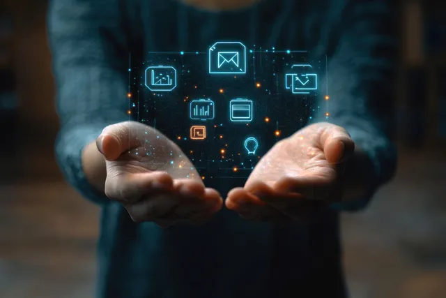 Man’s hands hold floating holographic education and communication icons above a blurred office scene.