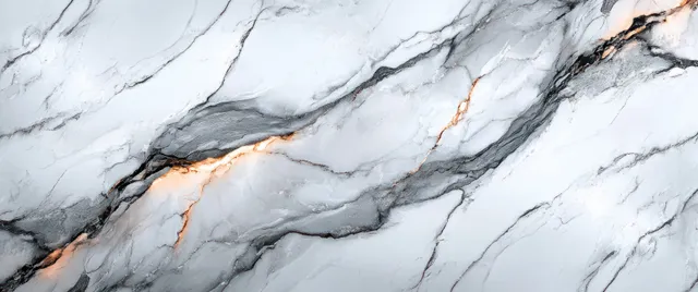 White marble stone surface showing flowing grey veins with subtle orange hairline accents in a close-up texture.