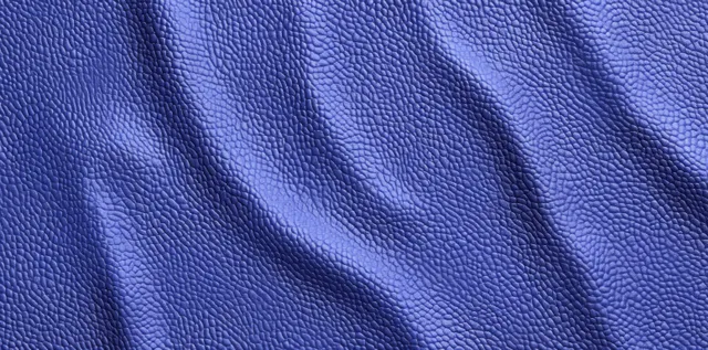 Close-up view of blue-purple leather texture with fine grain and gentle diagonal wrinkles.
