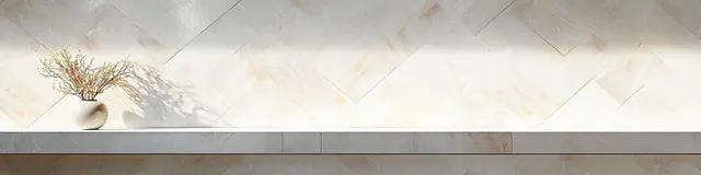 White marble wall with polished tile patterns and soft lighting creates a calm minimalist interior atmosphere.