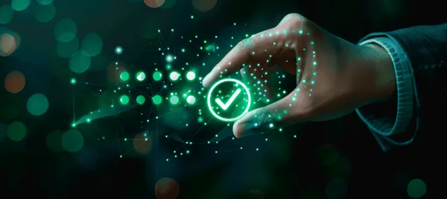 A business hand taps a glowing checkmark icon on a virtual quality dashboard amid digital particles.
