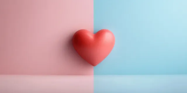 A red heart is centered on a vertically split pastel pink and blue background.
