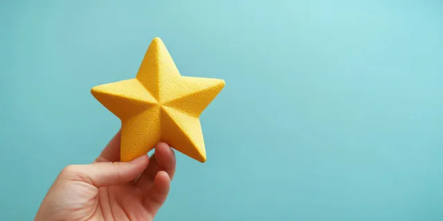 A hand holds a golden five-star award against a teal background.