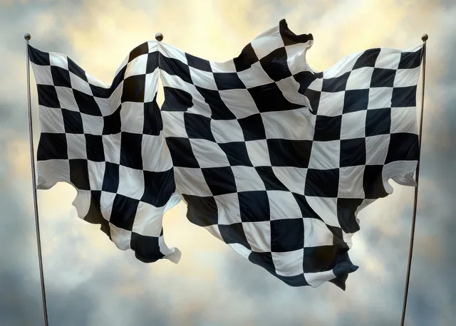 Three checkered black-and-white flags ripple on poles against a cloudy sky.