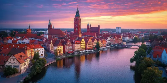 Aerial dusk panorama of Wrocław’s Cathedral Island over the Oder River with glowing Gothic spires