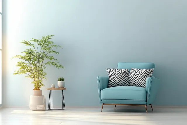 Light blue Scandinavian armchair with geometric cushions in a minimalist living room beside a small potted plant.