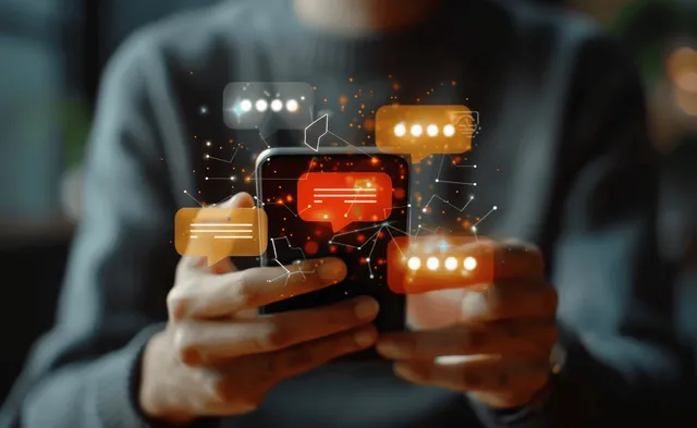 A man holds a smartphone while glowing chat bubbles and message icons float above the screen.